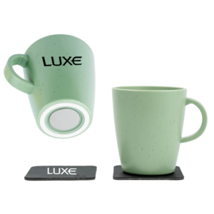 Set of green Silwy mugs with magnets on the bottom and the Luxe logo appearing on the mug and coaster