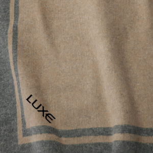 Throw Blanket with Luxe at an angle in the bottom corner